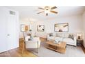 Bright living room featuring hardwood floors, modern furniture, and a ceiling fan at 5035 N 17Th Ave # 205, Phoenix, AZ 85015