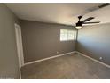 Bedroom features tile flooring, neutral walls and a modern ceiling fan fixture at 5042 S 22Nd St, Phoenix, AZ 85040