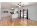 Bright living room with wood floors, ceiling fan, and sliding glass doors at 5135 E Evergreen St # 1166, Mesa, AZ 85205