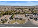 Expansive aerial view of property with large pool, lush greenery, and mountain views at 5827 S Marin Ct, Gilbert, AZ 85298