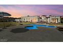 A serene backyard featuring a large private pool and outdoor lounging area at 5827 S Marin Ct, Gilbert, AZ 85298