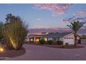 A single-story home showcasing a manicured front yard, brick accents, and a wide driveway at 6231 E Desert Cove Ave, Scottsdale, AZ 85254