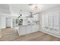 Modern kitchen featuring a large island, stainless appliances, and bright white cabinetry at 6629 N Majorca E Way, Phoenix, AZ 85016
