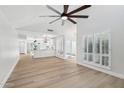 Bright, open-concept living space with wood flooring and shuttered windows at 6629 N Majorca E Way, Phoenix, AZ 85016