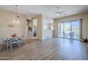 Open-concept living space featuring a dining area, wood floors, and sliding glass doors to the patio at 7094 E Palo Brea Dr, Gold Canyon, AZ 85118