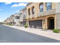 Contemporary townhome exterior with private garages and well-maintained landscaping at 7472 E Paraiso Dr, Scottsdale, AZ 85255