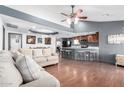 Open-concept living room flows into the kitchen with hardwood floors and neutral tones at 8132 E 3Rd Ave, Mesa, AZ 85208