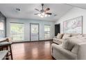 Bright living room with hardwood floors, ceiling fan, and large windows for natural light at 8132 E 3Rd Ave, Mesa, AZ 85208