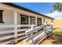 Inviting front porch with white railing and wood accents, offering a charming entrance at 8132 E 3Rd Ave, Mesa, AZ 85208