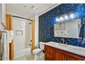 Tastefully updated bathroom features modern fixtures, bold patterned wallpaper, and a shower-tub combination at 9451 E Becker Ln # 1051, Scottsdale, AZ 85260