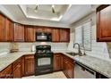 Well-maintained kitchen with granite counters, stainless steel appliances, and classic wood cabinetry at 9451 E Becker Ln # 1051, Scottsdale, AZ 85260
