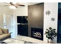 Living room with a decorative fireplace and adjacent half wall at 9451 E Becker Ln # 1051, Scottsdale, AZ 85260