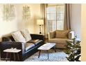 Living room with neutral colors, a comfortable sofa, chair and lots of natural light at 9451 E Becker Ln # 1051, Scottsdale, AZ 85260