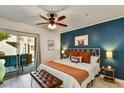 Comfortable bedroom with access to patio, showcasing a decorative blue accent wall and stylish furnishings at 9451 E Becker Ln # 1051, Scottsdale, AZ 85260