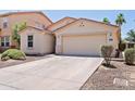 Charming single-level home with a two-car garage, neutral paint, and desert-friendly front yard at 973 E Kelsi Ave, San Tan Valley, AZ 85140