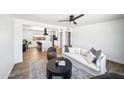 Open concept living room featuring modern furniture, a ceiling fan, and seamless access to the adjacent kitchen at 1017 E Diana Ave, Phoenix, AZ 85020