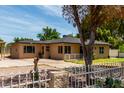 A front three-quarters view of a single-story brick home with large drive and desert landscaping at 1134 W 2Nd St, Mesa, AZ 85201