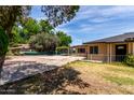 Rear and side view of a single-story home featuring an uncovered rear parking area at 1134 W 2Nd St, Mesa, AZ 85201