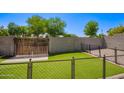 Fenced backyard featuring artificial turf, ideal for outdoor activities and pets at 12422 W Rosewood Dr, El Mirage, AZ 85335