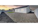 Expansive backyard featuring gravel and a cozy covered patio area for outdoor enjoyment at 14178 S Diablo Rd, Arizona City, AZ 85123