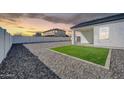 Spacious backyard features gravel landscaping and a small patch of grass at 14178 S Diablo Rd, Arizona City, AZ 85123