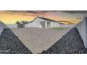 Large backyard offers ample space with gravel landscaping, potential for customization at 14178 S Diablo Rd, Arizona City, AZ 85123