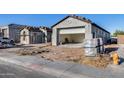 New construction home featuring modern architecture and a two-car garage, awaiting landscaping at 14687 N 73Rd Dr, Peoria, AZ 85381