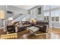 Bright living room featuring two sofas, hardwood floors, staircase and white railings at 15221 N Clubgate Dr # 2059, Scottsdale, AZ 85254