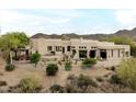 Aerial view of a house with a backyard featuring an outdoor grill and desert landscaping with mountain views at 15816 E Eagle Crest Rd, Fountain Hills, AZ 85268