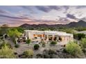An aerial view of the home's backyard oasis featuring desert landscaping and mountain views in the background at 15816 E Eagle Crest Rd, Fountain Hills, AZ 85268
