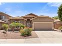 Single-story home featuring a well-maintained yard, desert landscaping and attached two-car garage at 15959 W Hearn Rd, Surprise, AZ 85379