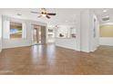 Open concept living area showcasing tile flooring, bright natural light, and seamless flow to the kitchen at 15959 W Hearn Rd, Surprise, AZ 85379