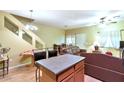 Spacious living room featuring hardwood floors, ceiling fan, and kitchen island for easy dining at 1718 W Colter St # 126, Phoenix, AZ 85015