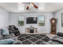 Bright living room with dark area rug, television, fireplace and a comfortable massage chair at 1733 N 77Th Dr, Phoenix, AZ 85035