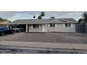 Well-maintained single-story home with freshly painted gray brick and manicured landscaping at 1813 E Boise St, Mesa, AZ 85203