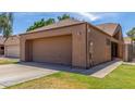 Exterior view of the home featuring a large two-car garage and a well-manicured lawn at 1836 N Stapley Dr # 191, Mesa, AZ 85203