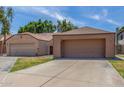 Exterior view of the home featuring a large two-car garage and a well-manicured lawn at 1836 N Stapley Dr # 191, Mesa, AZ 85203