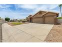 Lovely home with three-car garage, desert landscaping, and large driveway on a corner lot at 2189 E Ranch Ct, Gilbert, AZ 85296