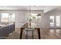 Dining area with hardwood floors, modern lighting, and large windows at 2339 W Ponderosa Ln, Phoenix, AZ 85023