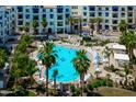 Relaxing pool area surrounded by palm trees, lounge chairs, and pristine landscaping at 2511 W Queen Creek Rd # 116, Chandler, AZ 85248