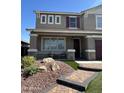 Inviting home with front porch and detailed landscaping enhances curb appeal at 29474 W Columbus Ave, Buckeye, AZ 85396