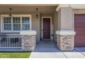 Inviting front porch with stone accents and decorative welcome sign by the front door at 29474 W Columbus Ave, Buckeye, AZ 85396