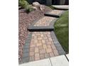 Close up of a paved walkway lined with rocks and artificial grass at 29474 W Columbus Ave, Buckeye, AZ 85396