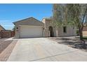 Charming home featuring a two-car garage and a welcoming front entry with a paved driveway at 30308 W Whitton Ave, Buckeye, AZ 85396
