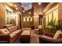 Charming outdoor patio featuring comfortable wicker furniture, string lights, and a cozy atmosphere for relaxing and entertaining at 3460 E Lynx Pl, Chandler, AZ 85249