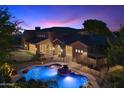 Lovely home exterior with a private backyard featuring a sparkling pool, covered patio and wrought iron fence at 3523 E Presidio Cir, Mesa, AZ 85213