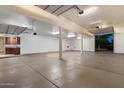 Spacious, well-lit garage with ample storage space and multiple overhead doors for convenient access at 3523 E Presidio Cir, Mesa, AZ 85213