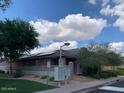 Exterior shot of community mailboxes and nearby home with solar panels on the roof at 3756 E Kerry Ln, Phoenix, AZ 85050