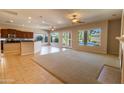 Inviting open-concept living space featuring carpet flooring, a fireplace, and a view of the backyard pool at 4241 E Andre Ave, Gilbert, AZ 85298