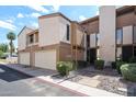 Charming townhouse with a private garage, landscaped walkway, and inviting front entrance at 6533 N 10Th Pl, Phoenix, AZ 85014
